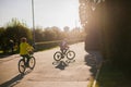 People cycling in the park at sunset