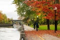 People cycling and walking in Rideau Canal Eastern Pathway. Autumn scenery in Ottawa