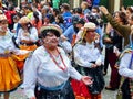 People and dancers dressed as caÃÂ±ari are spraying foam