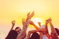 People dancing at the beach with hands up. concept about party, music and people Royalty Free Stock Photo