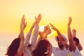 People dancing at the beach with hands up. concept about party, music and people Royalty Free Stock Photo