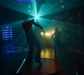 People dancing in disco lightshow Royalty Free Stock Photo