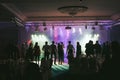 People dancing in the neon lights during the wedding party