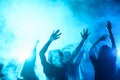 people dancing on party in nightclub with blue