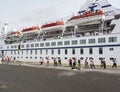 People dancing beside their cruise ship in the harbour