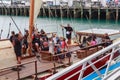 Passengers on board a twin-hulled Maori waka, Auckland, New Zealand