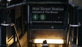 People descend to enter the Wall Street Subway Station in New York City