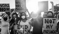 People from different ages and races protest on the street for equal rights - Demonstrators wearing face masks during black lives