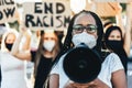 People from different ages and races protest on the street for equal rights - Demonstrators wearing face masks during black lives