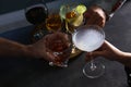 People with different alcohol drinks clinking glasses indoors, closeup Royalty Free Stock Photo