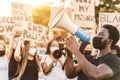 People from different culture and races protest on the street for equal rights - Demonstrators wearing face masks during black