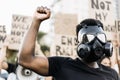 People from different culture and races protest on the street for equal rights - Focus on man face mask