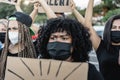 People from different culture and races protest on the street for equal rights with safety masks - Focus on left woman