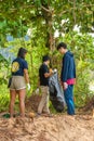 Khao Lak, Thailand, 1 june 2019: People of different nationalities cleaning garbage on the black beach to clean the beach in the