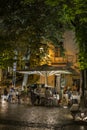 People dining alfresco in Lisbon at dusk