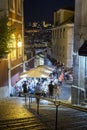 People dining alfresco in downtown Lisbon at dusk