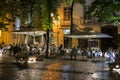 People dining alfresco in Lisbon at dusk