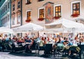 People dining at outdoor restaurant in Krakow.