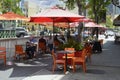 People dining outside under orange umbrellas in Little Italy, San Diego CA Royalty Free Stock Photo