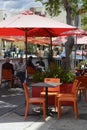 People dining outside under orange umbrellas in Little Italy, San Diego CA Royalty Free Stock Photo