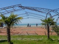 People disassemble the structure on the beach. Resort. Tent frame. Preparing for the season Royalty Free Stock Photo