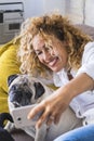 People and dog stay at home concept with cheerful happy beautiful adult woman taking selfie picture with her best friend pug Royalty Free Stock Photo