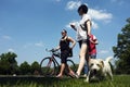 People and a dog walking in a park