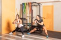 People doing adductor stretch exercise in gym