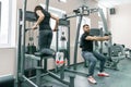 People doing exercises on simulators in the gym. Fitness, sport, training, people, healthy lifestyle concept