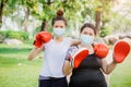People doing sport boxing activity with friend and wear face mask for stimulate immunity at outdoor park