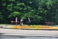 People doing sports near a flower bed in the park