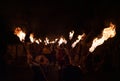 People dressed in medieval dresses and armored knights with a flaming torches during a fire procession deep night shot in Zilina,