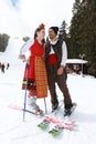 People dressed with traditional Bulgarian clothes skiing with the Bulgarian national flag. Royalty Free Stock Photo