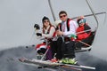 People dressed with traditional Bulgarian clothes skiing with the Bulgarian national flag. Royalty Free Stock Photo