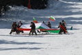 People dressed with traditional Bulgarian clothes skiing with the Bulgarian national flag. Royalty Free Stock Photo