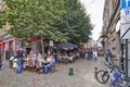 People drink, eat and talk on the terrace of a cafe