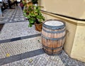 people drink from old barrique barrels in front of the restaurant.