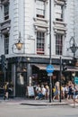 People drinking outside The Old Crown pub on New Oxford Street, London, UK. Royalty Free Stock Photo