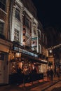 People drinking outside The Two Brewers Greene King pub in Covent Garden, London, UK