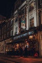 People drinking outside The Two Brewers Greene King pub in Covent Garden, London, UK