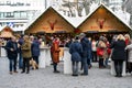 People on Cmarket in front of stalls with mulled wine, punch at Dusseldorf Christmas market. Village in front of modern buildings