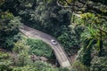 People drive luxury convertible car on scenic tropical road to Hana in Maui, Hawaii Royalty Free Stock Photo