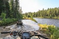 People driving ATV quadbike through water. Lake in Ontario, Canada. Royalty Free Stock Photo