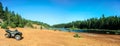 People driving ATV quads on sand beach at lake Royalty Free Stock Photo