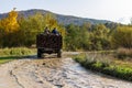 People driving dangerously on a fully loaded truck in the mountains of the Ukrainian Carpathians. Royalty Free Stock Photo