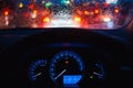 People driving modern car in night time with light and drop of water bokeh Royalty Free Stock Photo