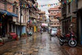 People Driving in the Rain in Kathmandu Patan Durbar Marg