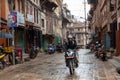 People Driving in the Rain in Kathmandu Patan Durbar Marg