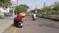 People driving vehicles in the busy Street