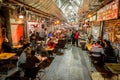 People eat and drink on a food court in the evening at the Machane Yehuda Market in Jerusalem, Israel